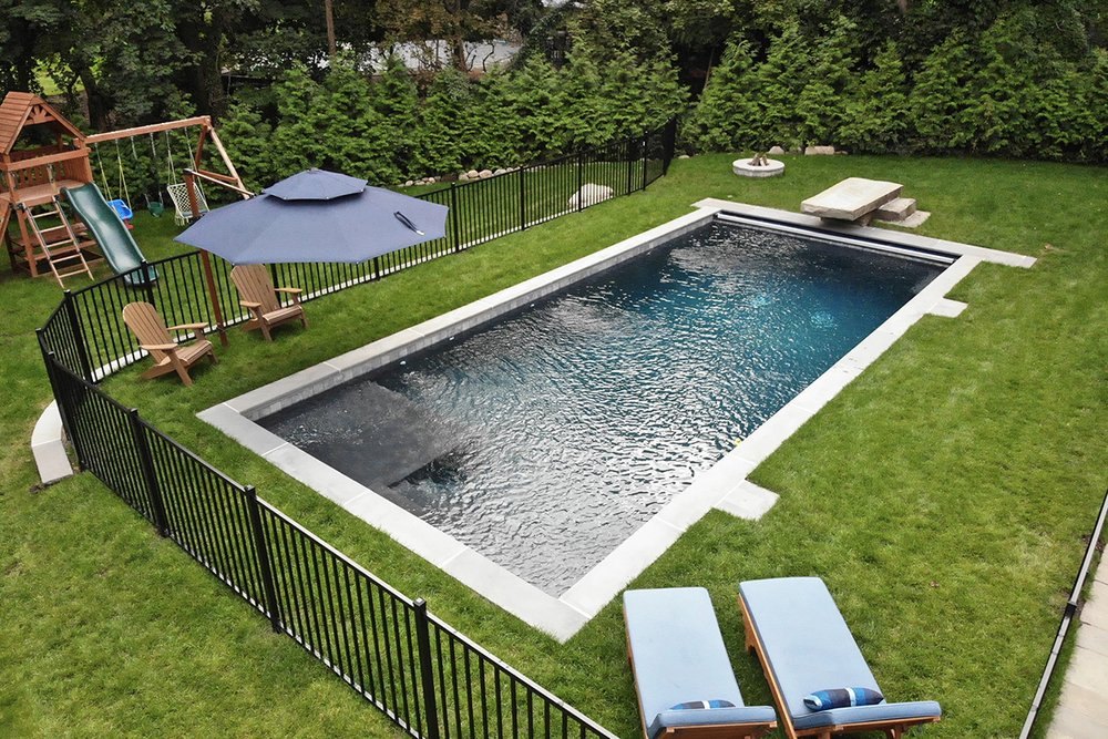 Residential in-ground pool with safety fence inspected by Aquatic Pool Inspections in New Jersey